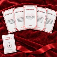 Five Romantic Set cards from the Intimacy Advent Calendar fanned out on red velvet, with a Day 7 envelope