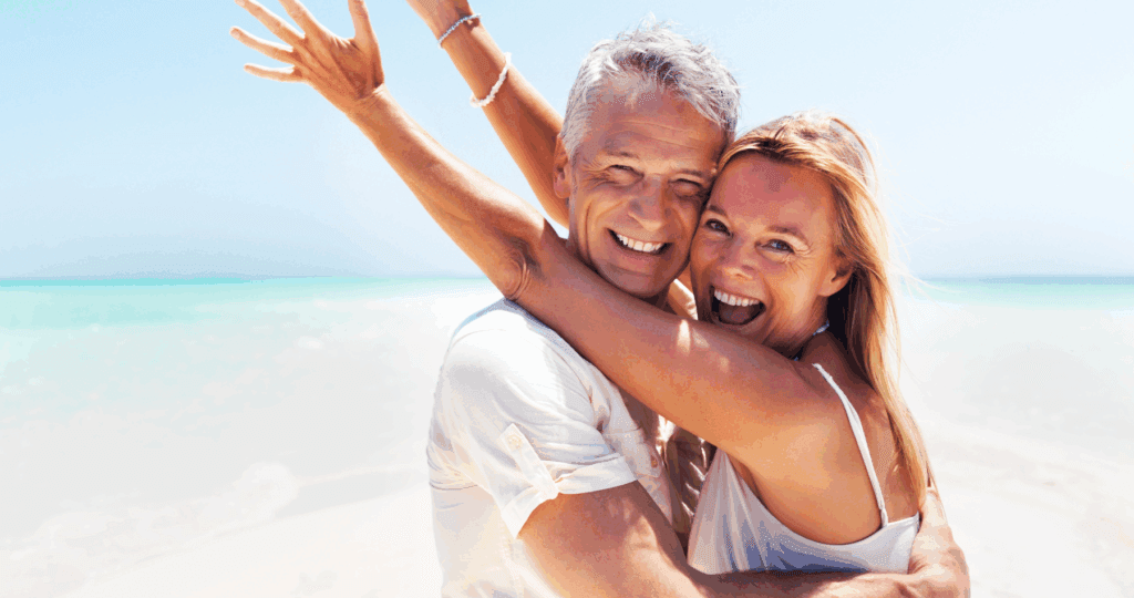 Couple celebrating their coaching wins on a beautiful beach.
